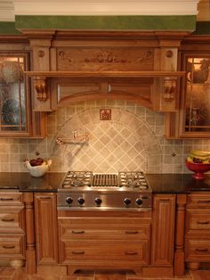 a stove top oven sitting inside of a kitchen next to wooden cupboards and counter tops