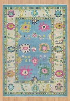 a blue rug with colorful flowers on it