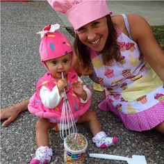 a woman holding a baby in her arms and whisk them with a whisk