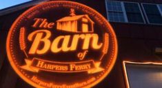 the barn of harper's ferry is lit up at night with bright orange lights