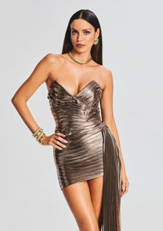 Embrace your inner goddess in our Daniele Dress. Crafted in lustrous lamé, this mini silhouette features ruched panels on the bodice and a long sash draped from the waist. The strapless neckline and asymmetric hem provide the silhouette with a seductively feminine feel. The style is finished with an invisible side zip closure. Shown here in Metallic Bronze. 95% Polyester, 5% Spandex Made in China Model is 5'11" wearing size S Style No. SS23-6576 Dress With Metal Details, Sherri Hill Mini Dress, Pink Hoco Dress, Bronze Dress, Lame Dress, Australia Clothes, Hoco Dress, Denim Essentials, Summer 2025