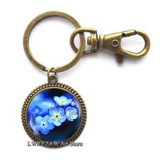 PRICES MAY VARY. Material: Alloy & Glass Cabochon ,Color:as shown Christmas Keychain,best gift to your friends,family Keychain Size: 3.5cm*2.8cm,Cabochon Diameter: 2.5cm,Base Diameter:2.5cm. 100% Brand New And High Quality.Handmade item,Packing gift bag,Everyday keychain,Fast delivery Beautiful handmade Keychain for yourself or loved one.Chirstmas Gift,photo jewelry,wedding jewelry，valentines day gifts,best friend gifts,birthday gifts,anniversary gifts,friendship gifts Material: Alloy & Glass Ca Blue Flower Charm Jewelry As Gift For Her, Round Keepsake Jewelry With Flower Charm, Blue Keychain With Key Clip For Gift, Blue Flower-shaped Jewelry With Flower Charm, Blue Round Pendant Necklace With Pressed Flowers, Glass Theme, Valentines Jewelry, Friend Birthday Gifts, Friendship Gifts