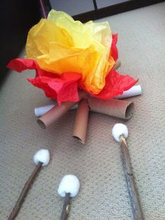 several toothbrushes are laying on the floor next to some tissue paper