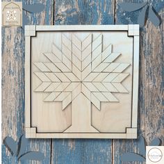 a wooden snowflake cutout on a blue wood background