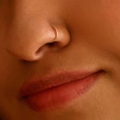 a close up view of a woman's nose and nose with a ring on it