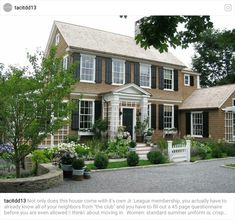 a large brown house with black shutters and white trim