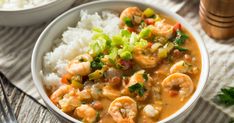 two bowls filled with shrimp and rice on top of a table