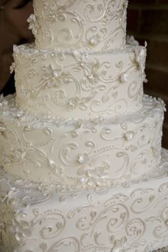 a large white wedding cake sitting on top of a table