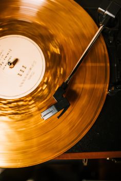 an old record player with gold colored vinyl