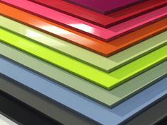 a stack of multicolored plastic sheets sitting next to each other on top of a table