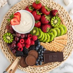 a platter filled with fruit, crackers and chocolate