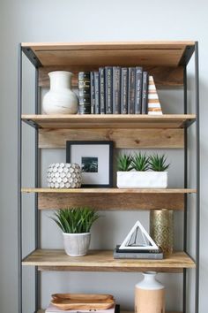 a book shelf filled with books and plants