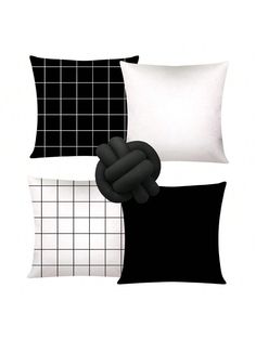 a black and white pillow with a hand holding the pillow