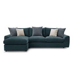 a blue sectional couch with pillows on it's back and side facing each other