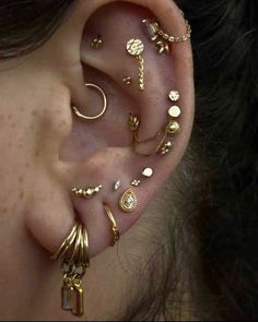 an ear with several different types of piercings on it