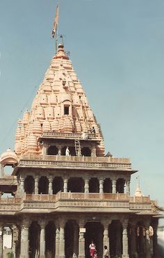 an old building with people standing in front of it