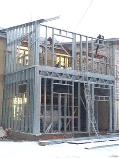 a house being built with metal framing on the front and side of it's roof