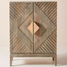 a wooden cabinet with geometric designs on it