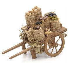 an old wooden wagon filled with lots of nuts and other things on it's wheels