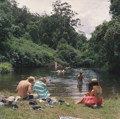 some people are sitting in the water by themselves