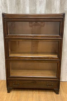 an old wooden bookcase with three drawers