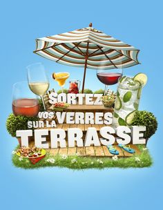 an advertisement for some type of beverage on the grass with glasses and umbrellas above it