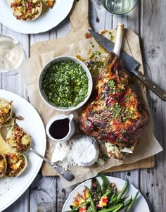 a table topped with white plates filled with food