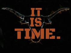 it is time with an orange and black bull's head in the center on a black background