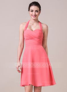 a woman in a pink dress posing for the camera