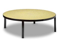 a round table with black legs and yellow patterned top