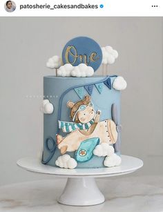 a blue and white cake with an animal on top