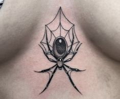 a spider tattoo on the back of a woman's chest