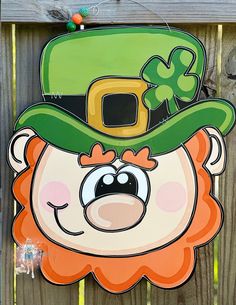 a st patrick's day sign hanging on a fence