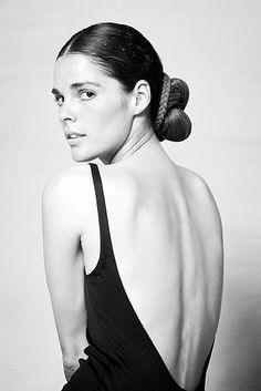 black and white photograph of a woman with her back to the camera, wearing a halter top