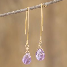 Two lavender cubic zirconia grace these slender earrings to create delicate drops. They are the creation of Costa Rican fine artist Guisselle Mora whose love for earrings and more came from the treasures she saw in her grandmother's jewelry box. The stainless steel is bathed in radiant 18k gold for timeless glamour. Raindrop Earrings, Grandmother Jewelry, Lavender Earrings, Timeless Glamour, Costa Rican, Purple Jewelry, Purple Earrings, Hair Jewelry Wedding, Fine Artist