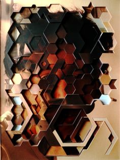 a woman's face is reflected in a mirror with hexagonal shapes on it