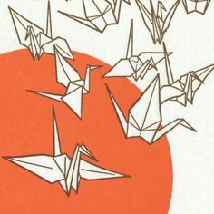 some origami birds are flying in the air over an orange and white background