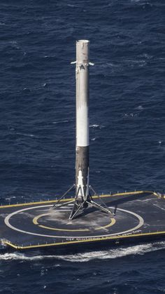 an aerial view of a space shuttle on top of a floating platform in the middle of the ocean