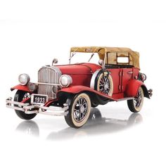 an old model red car on a white background