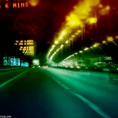 a blurry photo of cars driving down a street at night