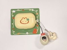 a hello kitty phone holder with two little kittens attached to the back of it