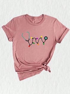 a pink t - shirt with the word love spelled in lights on it's chest