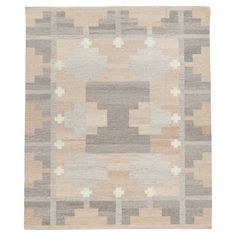 a beige and grey rug with squares on it