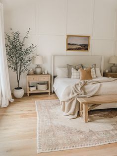 a bed room with a neatly made bed and a rug