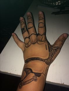 a person's hand with some tattoos on it