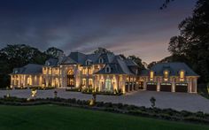 a large house with lots of windows and lights