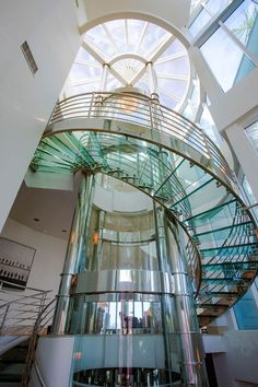 a spiral glass staircase in an office building