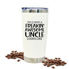 a white tumbler with the words freakin'awesome uncle looks like surrounded by coffee beans