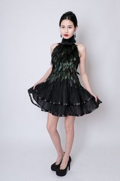 Qi Pao, Chinese inspired black feather dress with mandarin collar and Asian clasp at throat. Each feather is carefully trimmed and hand applied to a natural kona cotton dress base. Feathers are originally green and gold and dyed black. They have a glossy iridescent sheen and the green and gold tones can be seen in bright sunlight and flash photography. Skirt is soft layers of black tulle with ribbon detailing. Zipper closure in black.This dress is made to measure. Please contact me for custom si Black Cocktail Dresses With Ostrich Feathers, Black Ostrich Feather Cocktail Dress, Black Feather Dresses For Spring, Black Feathered Dresses For Spring, Feathered Dresses For Costume Party, Peacock Feather Dress, Black Feather Dress, Qi Pao, Ballerina Skirt