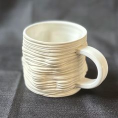 a stack of white cups sitting on top of a table